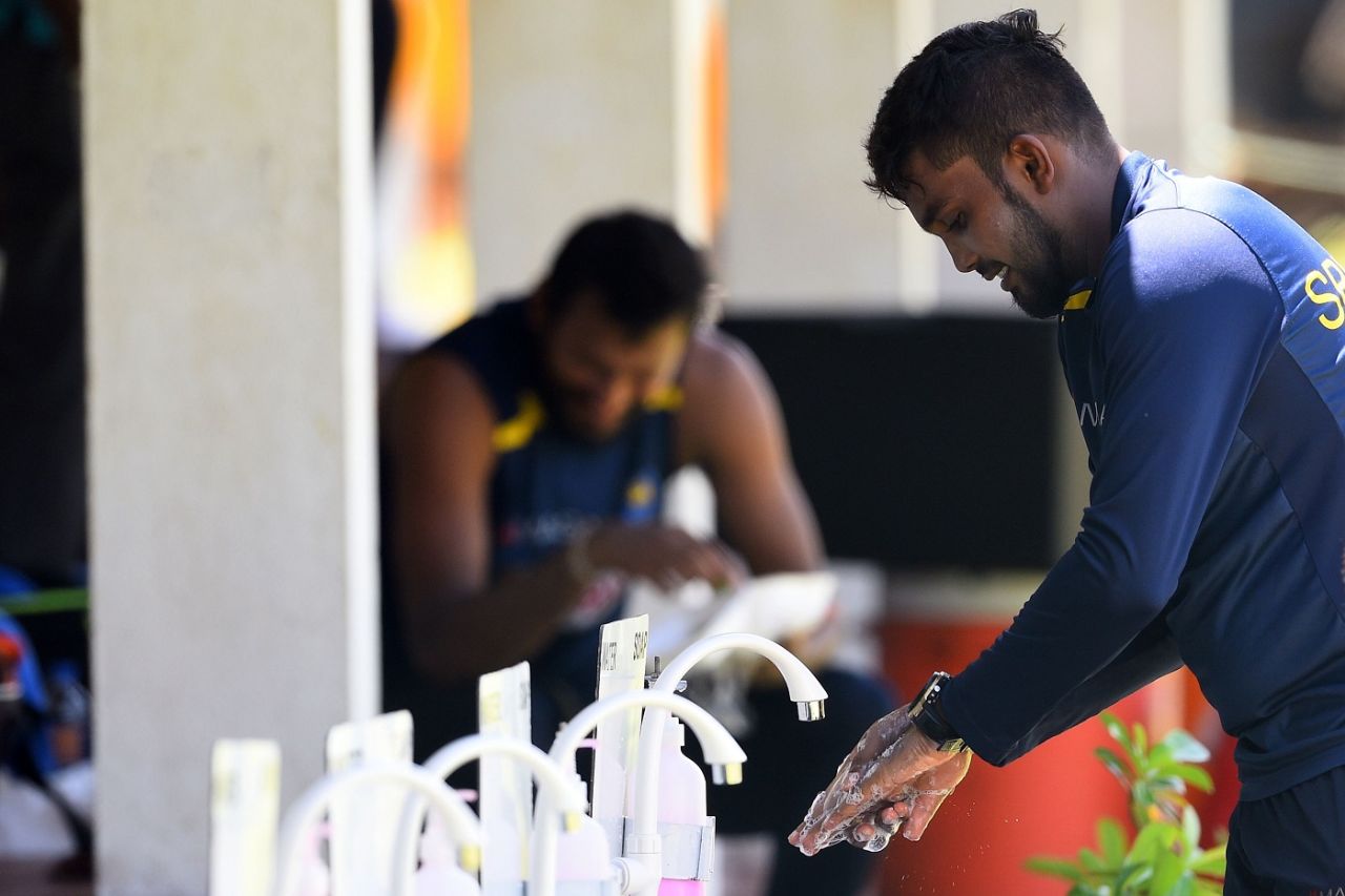 Wanindu Hasaranga washes his hands after a practice session at the Colombo Colts Cricket Stadium, Colombo, June 2, 2020