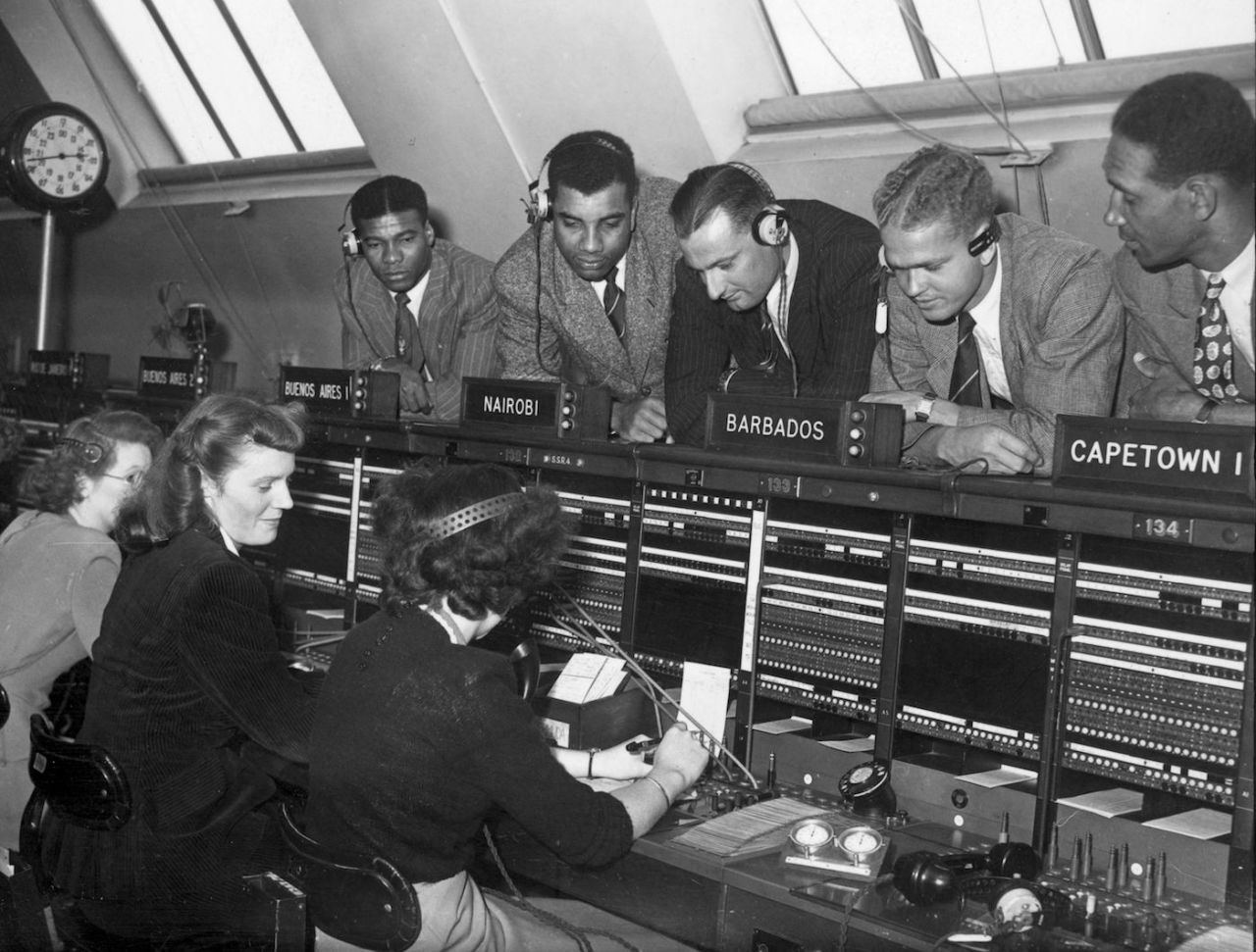 West Indies cricketers watch a telephone operator putting calls through to the West Indies for them from England, London, August 18, 1950