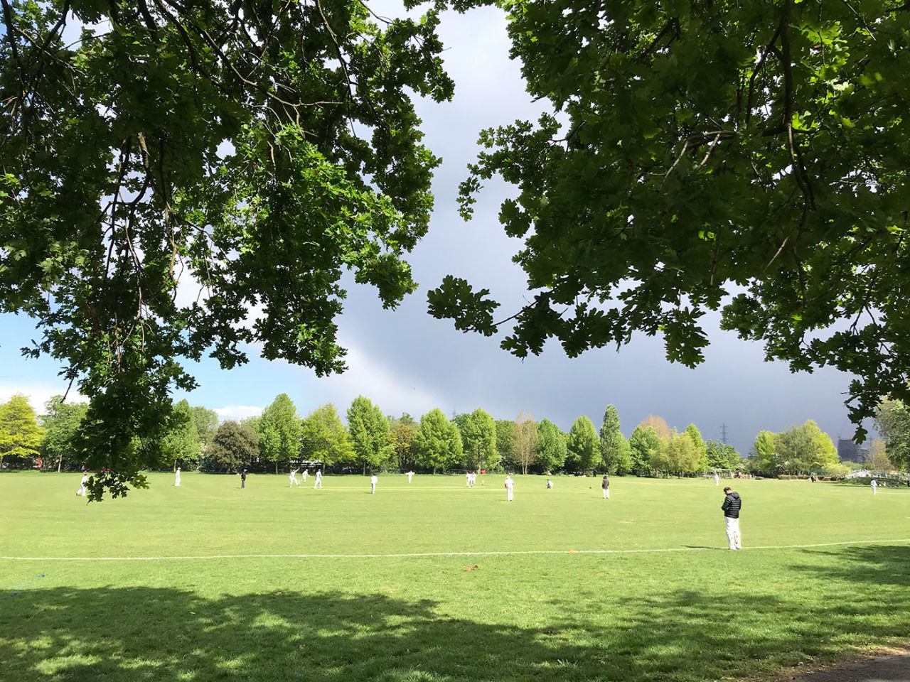 A club cricket match takes place in Springfield Park, East London, May 4, 2019