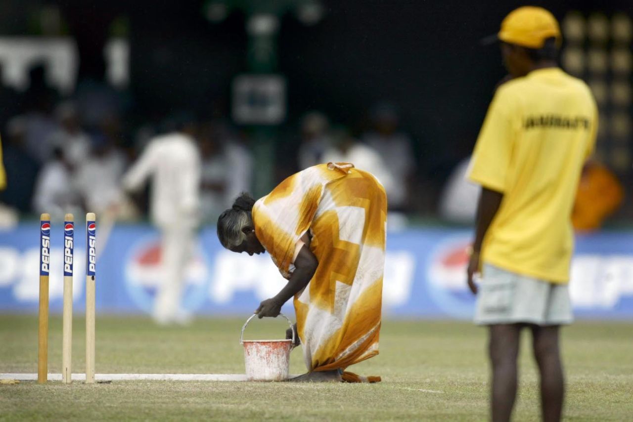 Groundstaff attend to the wicket as rain stops play, fourth day, first test, Pakistan v Australia , P Sara Stadium, Colombo, Sri Lanka, October 6, 2002. 