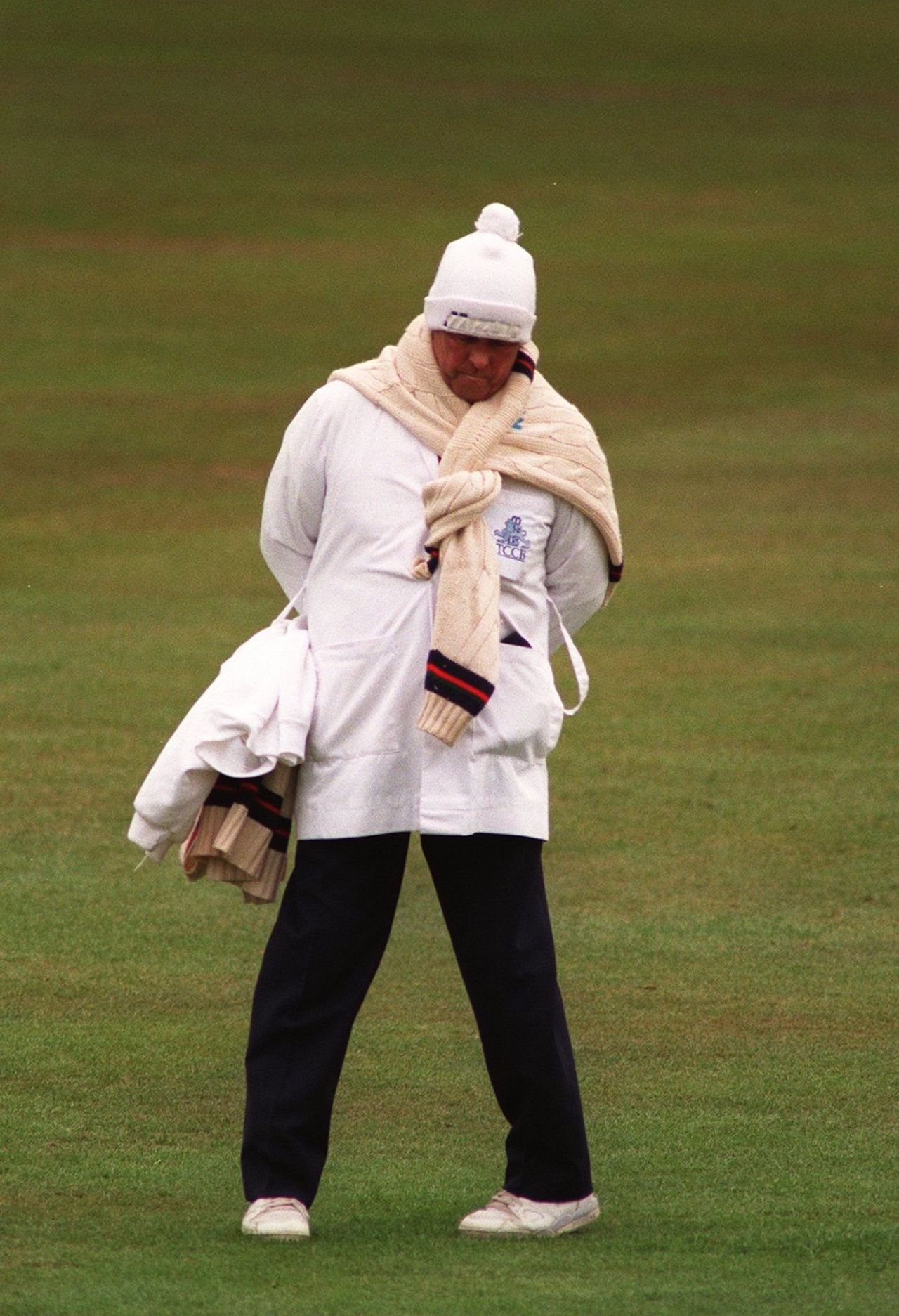Umpire Jack (John) Hampshire feels the cold during the Nottinghamshire v Lancashire game, Trent Bridge, May 16, 1996