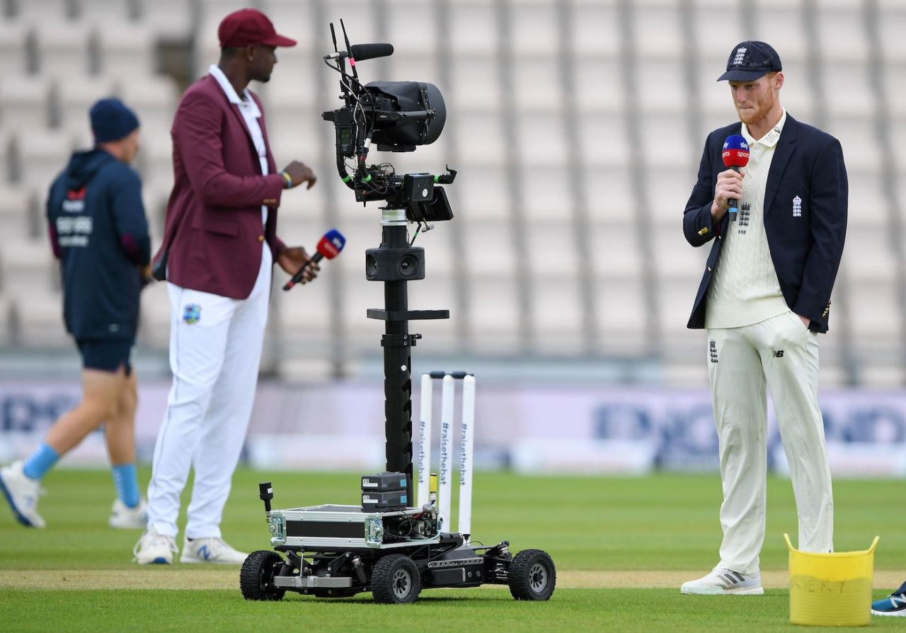 Ben Stokes and Jason Holder hold microphones as they talk into a remote television broadcast camera, first day, first Test, England v West Indies, Ageas Bowl, Southampton, July 8, 2020