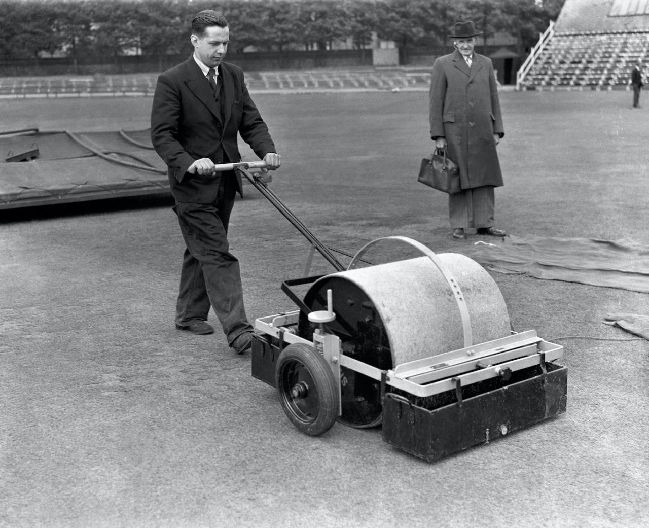 The groundsman uses a new device to dry the pitch, The Oval, July 23, 1953