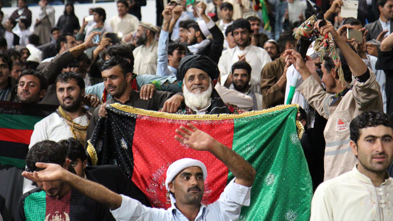 An Afghanistan fan proudly unfurls the tricolour flag in victory, UAE v Afghanistan, Desert T20, Group A, Abu Dhabi, January 16, 2017