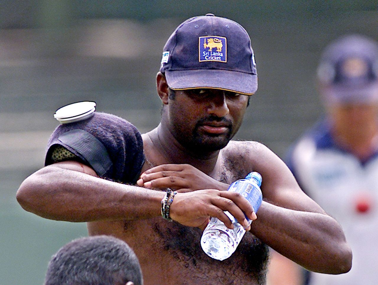 Muttiah Muralitharan puts an ice pack on his shoulder, Colombo, August 10, 2004