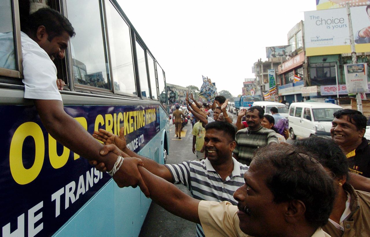 Muttiah Muralitharan leans out of the team bus to shake hands with fans, Colombo, May 3, 2007