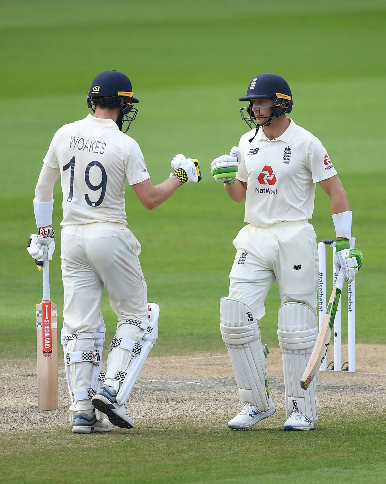 Jos Buttler and Chris Woakes punch gloves, England v Pakistan, 1st Test, Old Trafford, 4th day, August 8, 2020