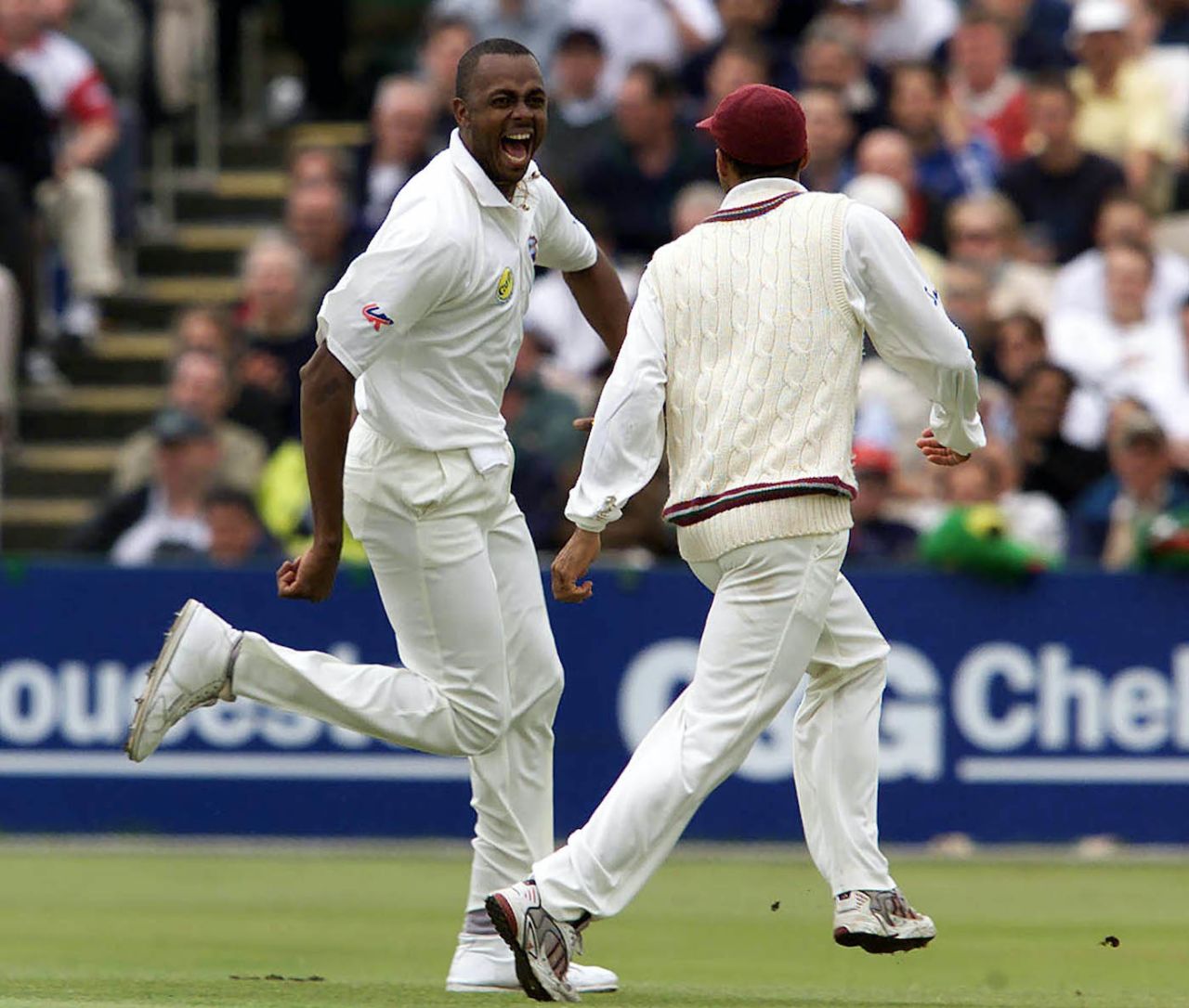 Courtney Walsh celebrates with Jimmy Adams after removing Nasser Hussain and Graham Thorpe in successive balls, second day, Third Test, Old Trafford, August 4, 2000