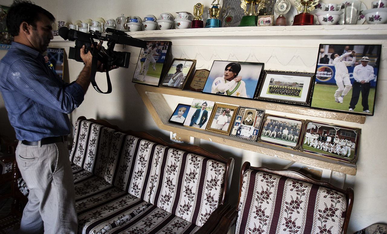 A cameraman films inside Mohammad Amir's home on the day of his sentencing, Gujar Khan, Pakistan, November 3, 2011