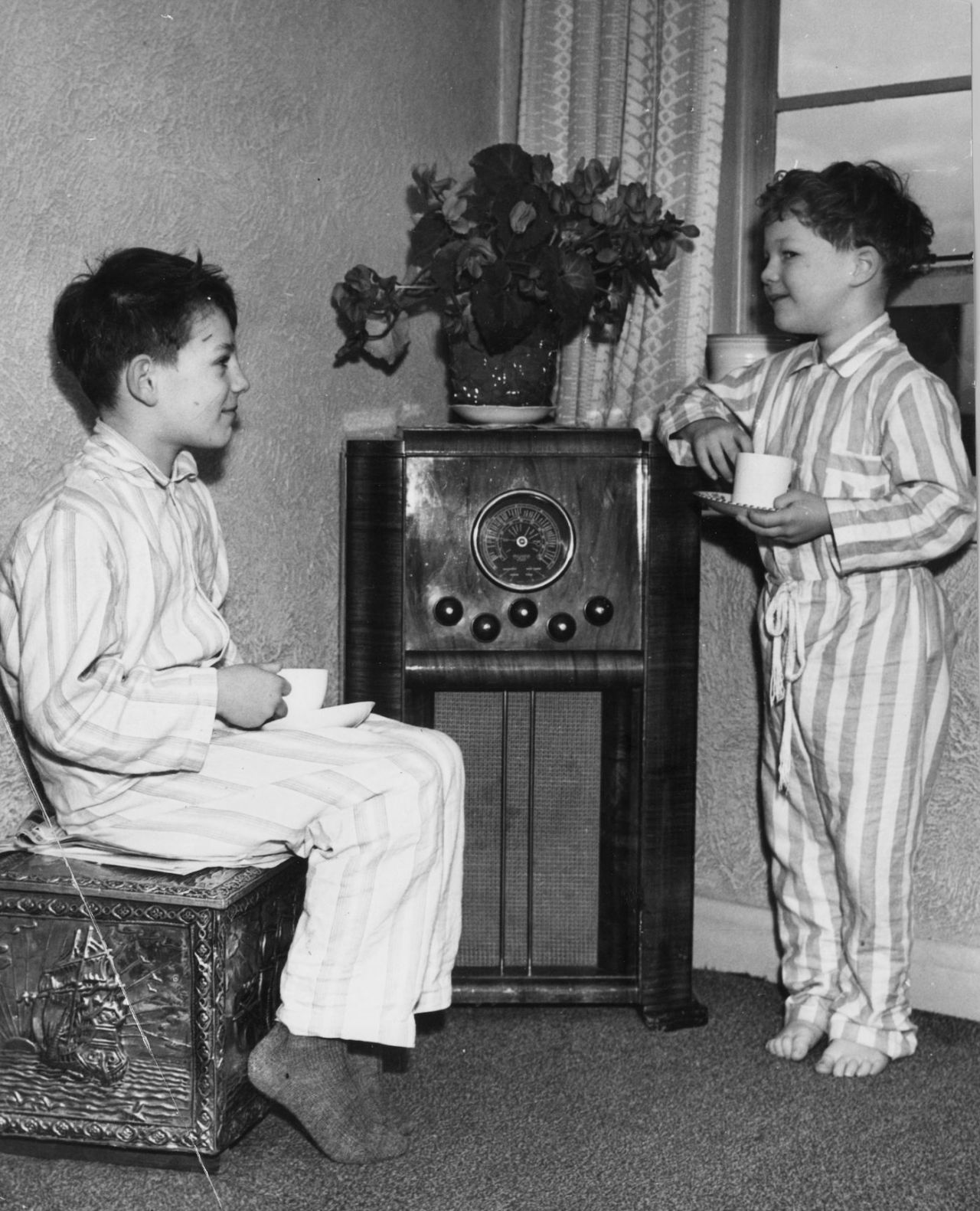 Richard (left) and John Hutton, sons of Leonard Hutton, listen to a broadcast of a Test match in Australia in which their father is playing, Leeds, February 07, 1951
