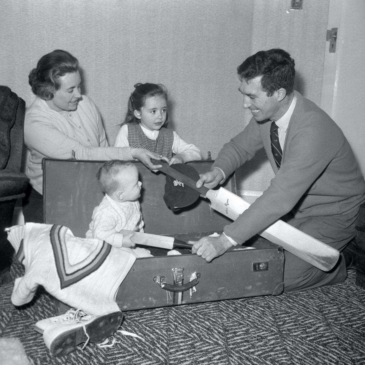 Nine month old Mark Titmus helps his father Fred Titmus pack for the MCC tour of India and Pakistan, December 18, 1963