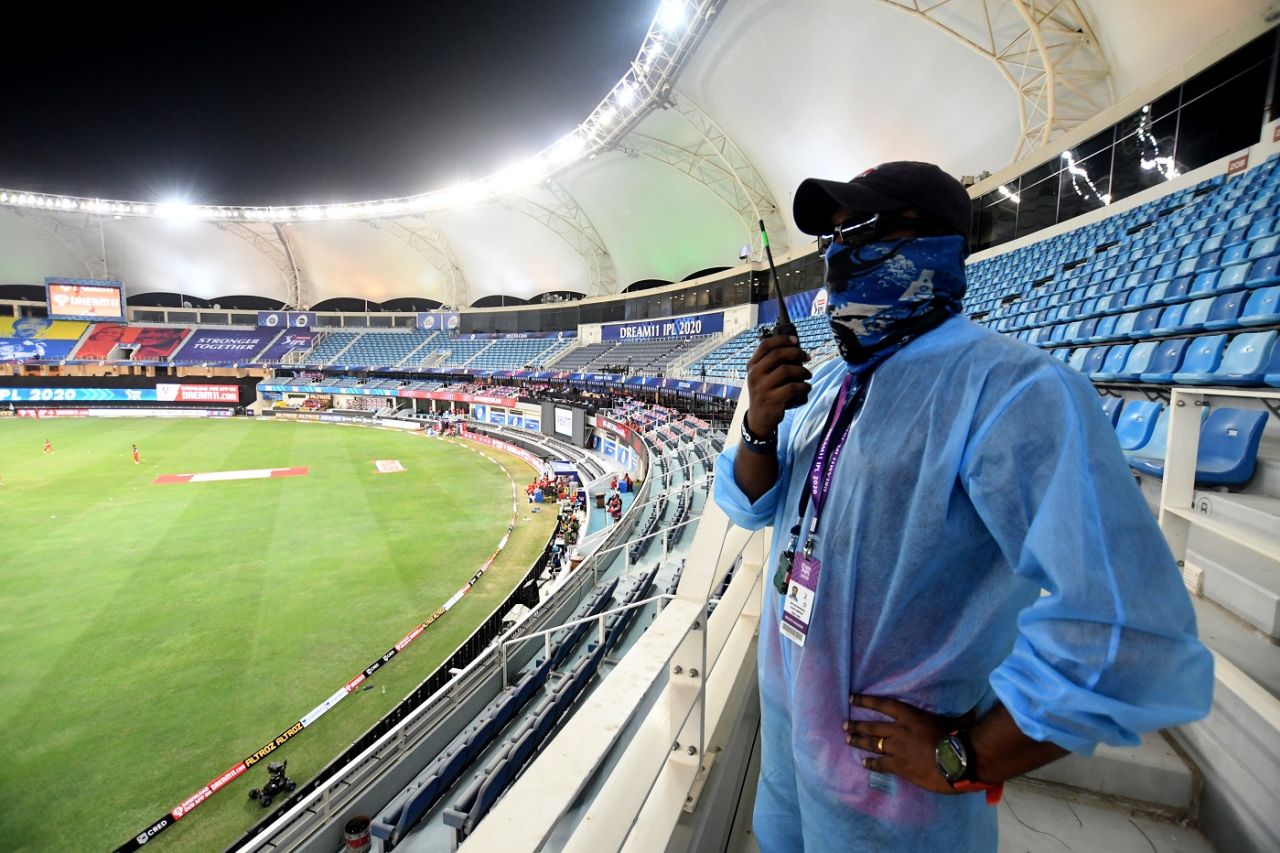 An IPL crew member, dressed in PPE kit, communicates on a walkie-talkie, Kings XI Punjab vs Royal Challengers Bangalore , IPL 2020, Dubai, September 24, 2020