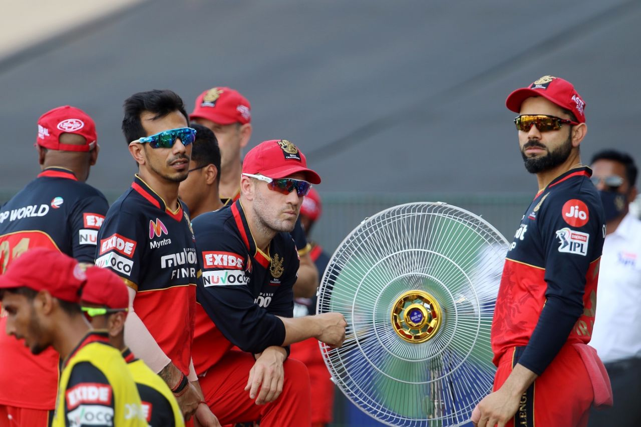 Virat Kohi, Yuzvendra Chahal and other RCB players gather around a large fan to beat the heat in this year's first day game, Royal Challengers Bangalore v Rajasthan Royals, IPL 2020, Abu Dhabi, October 3, 2020