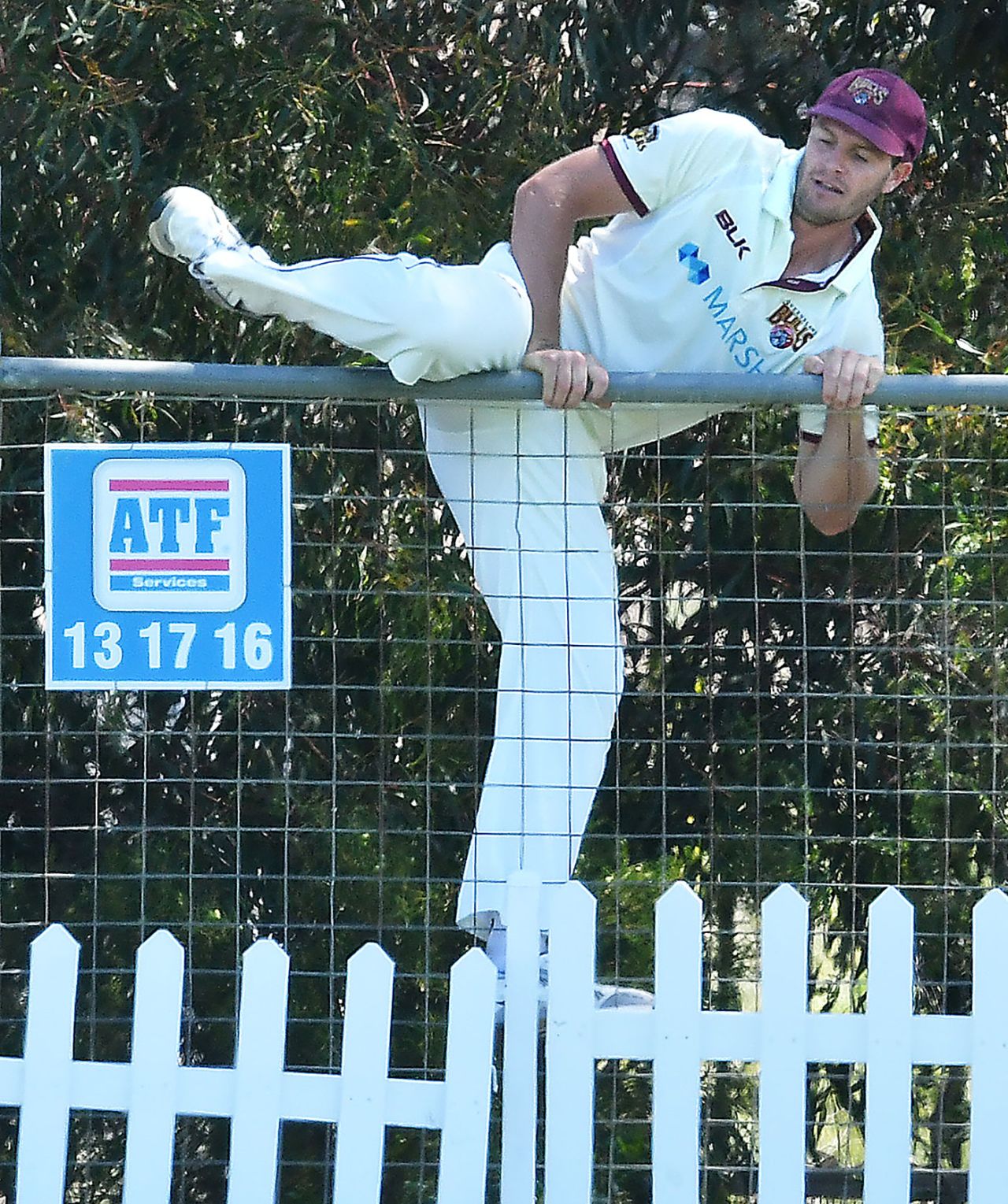 Mark Steketee clambers the fence to retrieve the ball, Queensland v Tasmania, Sheffield Shield, Park 25, Adelaide, October 10, 20202