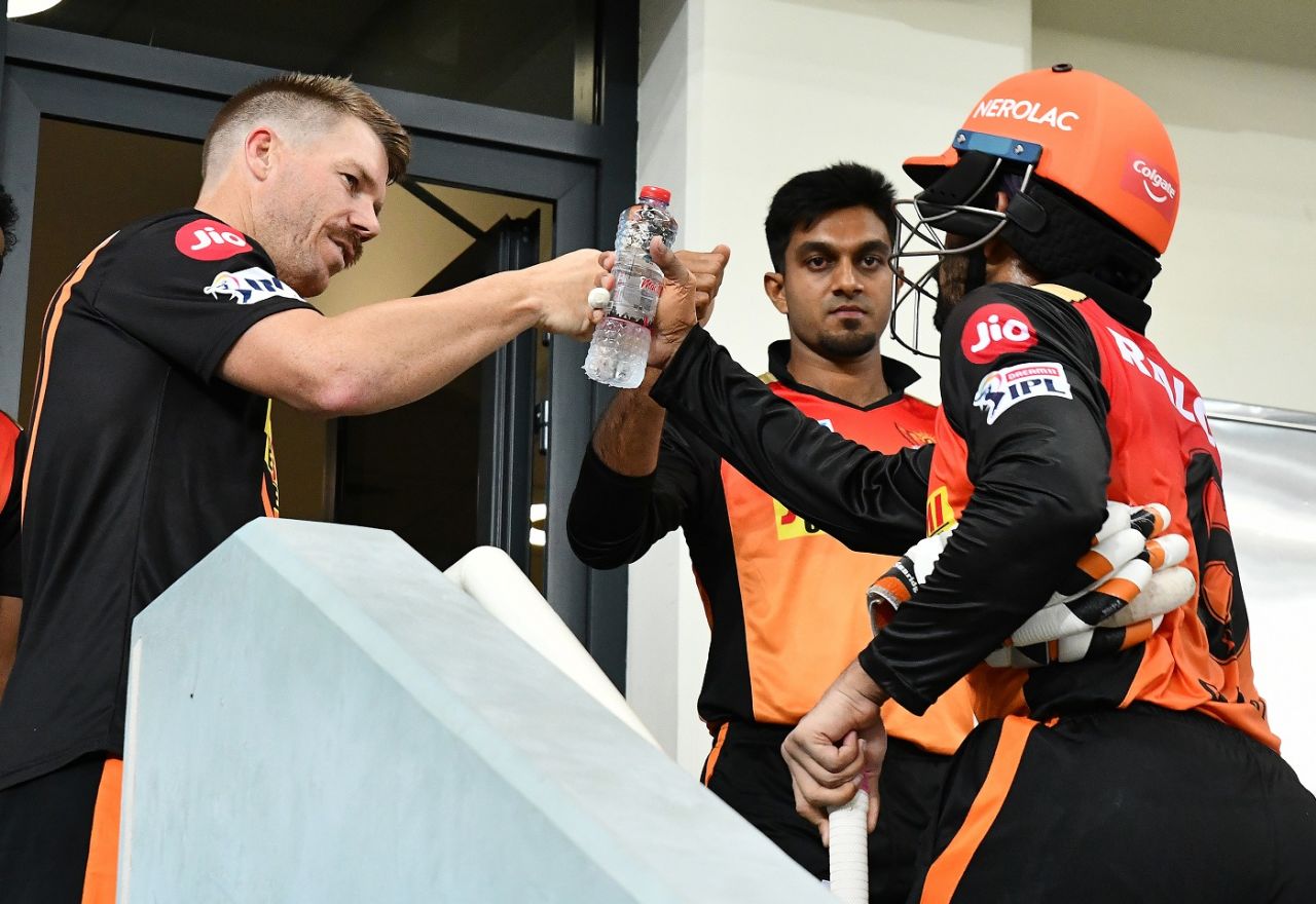 David Warner bumps fists with Wriddhiman Saha after the latter's innings ended just short of a century, Sunrisers Hyderabad vs Delhi Capitals, IPL 2020, Dubai, October 27, 2020
