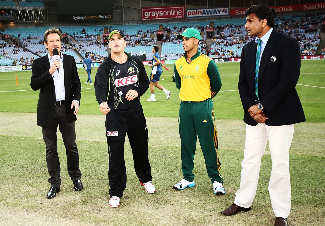 Aaron Finch tosses the coin, watched by commentator Mark Nicholas, South Africa captain JP Duminy and match referee Javagal Srinath, Australia v South Africa, 3rd Twenty20, Sydney, November 9, 2014