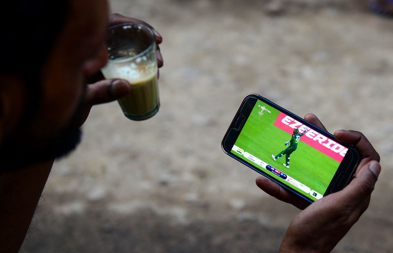 A fan watches a live stream of a match on their mobile phone