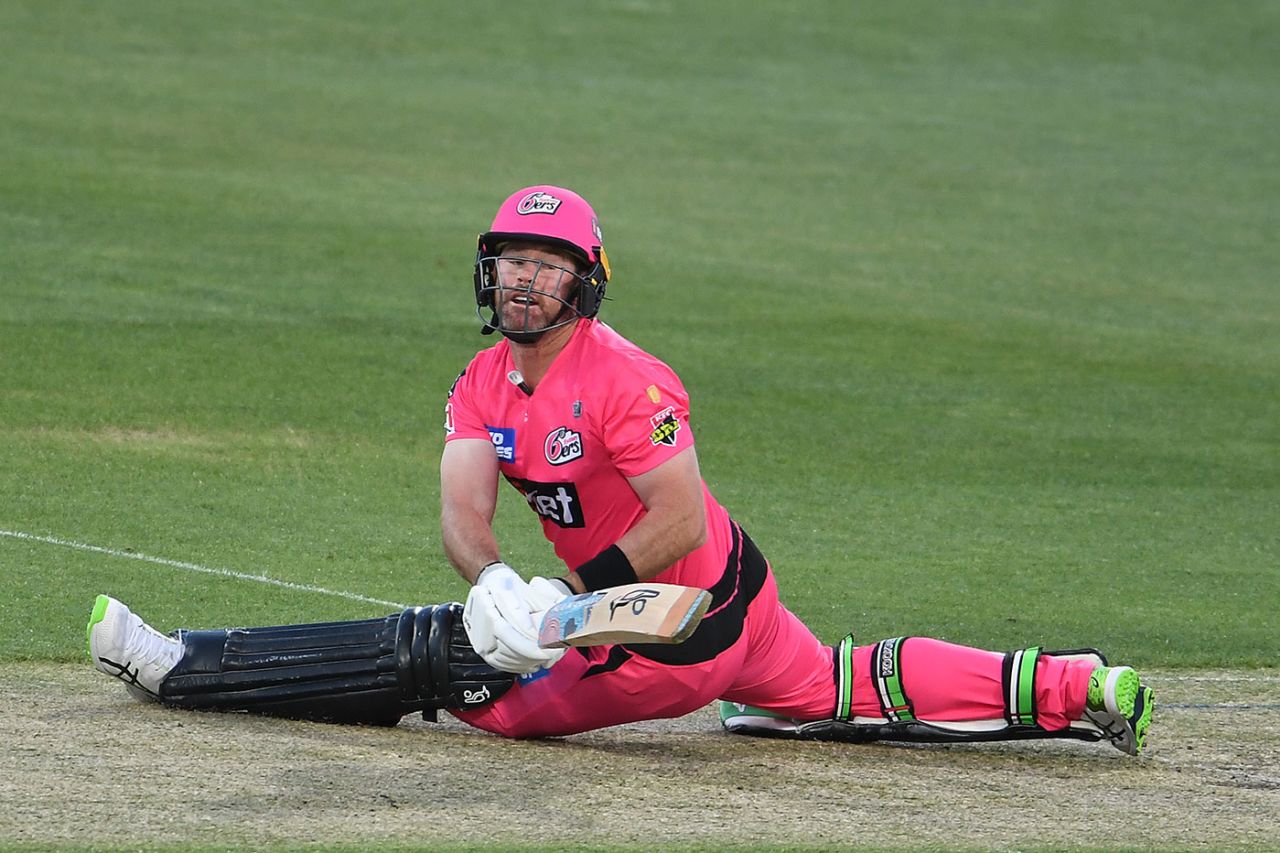 Dan Christian gets into an awkward position as he sweeps, Sydney Sixers v Adelaide Strikers, BBL, Hobart, December 20, 2020