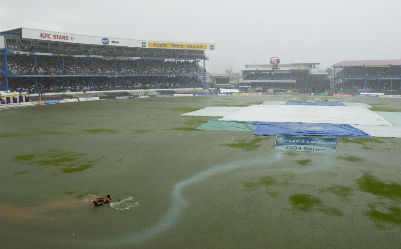A fan plays about in the water as rain floods the pitch, second ODI, West Indies vs England, Queens Park Oval, Port of Spain,Trinidad, April 24, 2004
