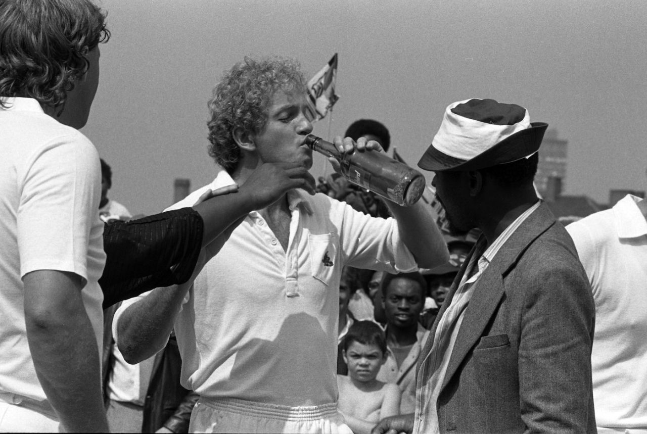 Ian Botham watches as David Gower takes a swig from a bottle of Thunderbird wine, fifth day, fifth Test, England vs West Indies, The Oval, August 14, 1984