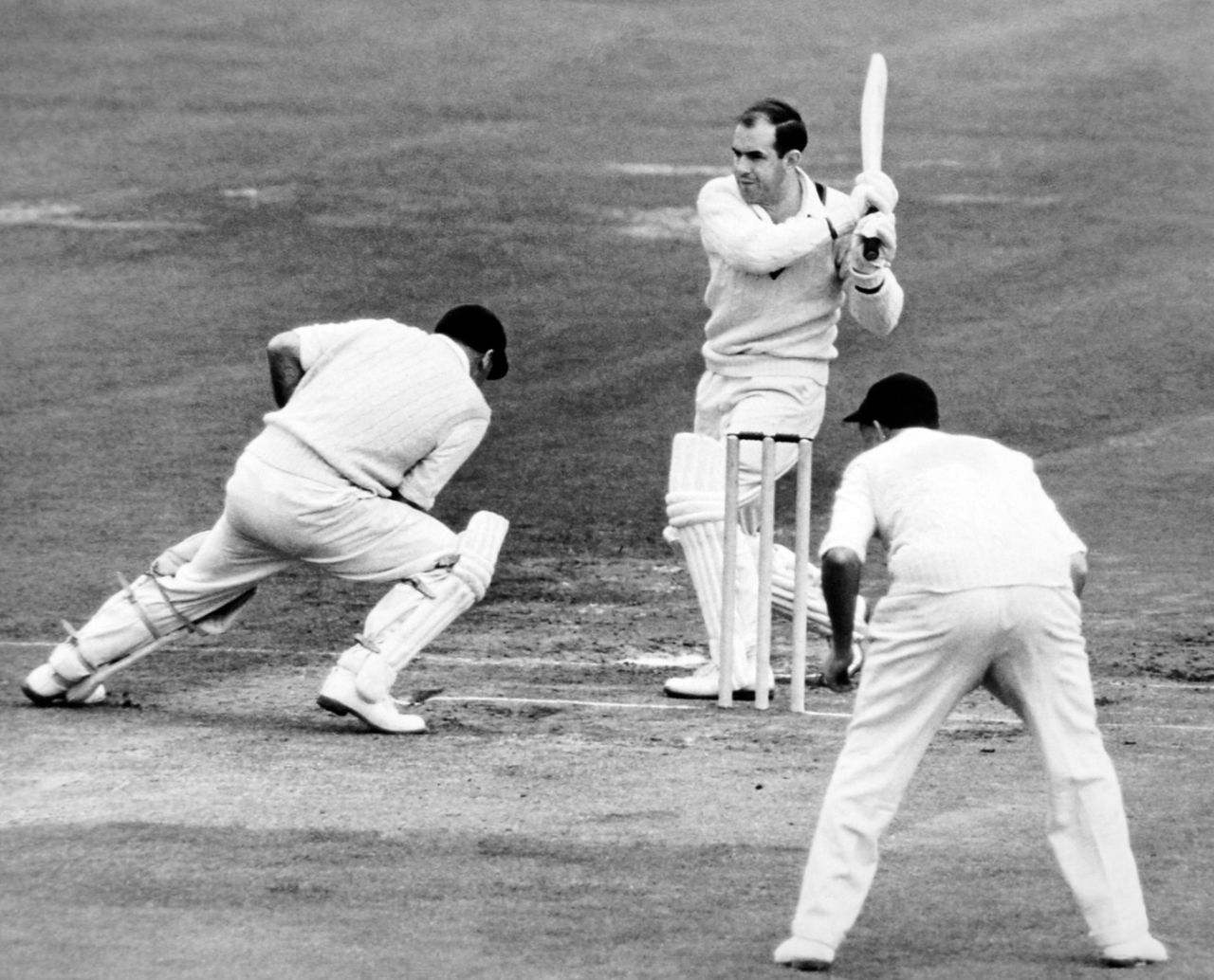 Colin McDonald swings Tony Lock away for a boundary