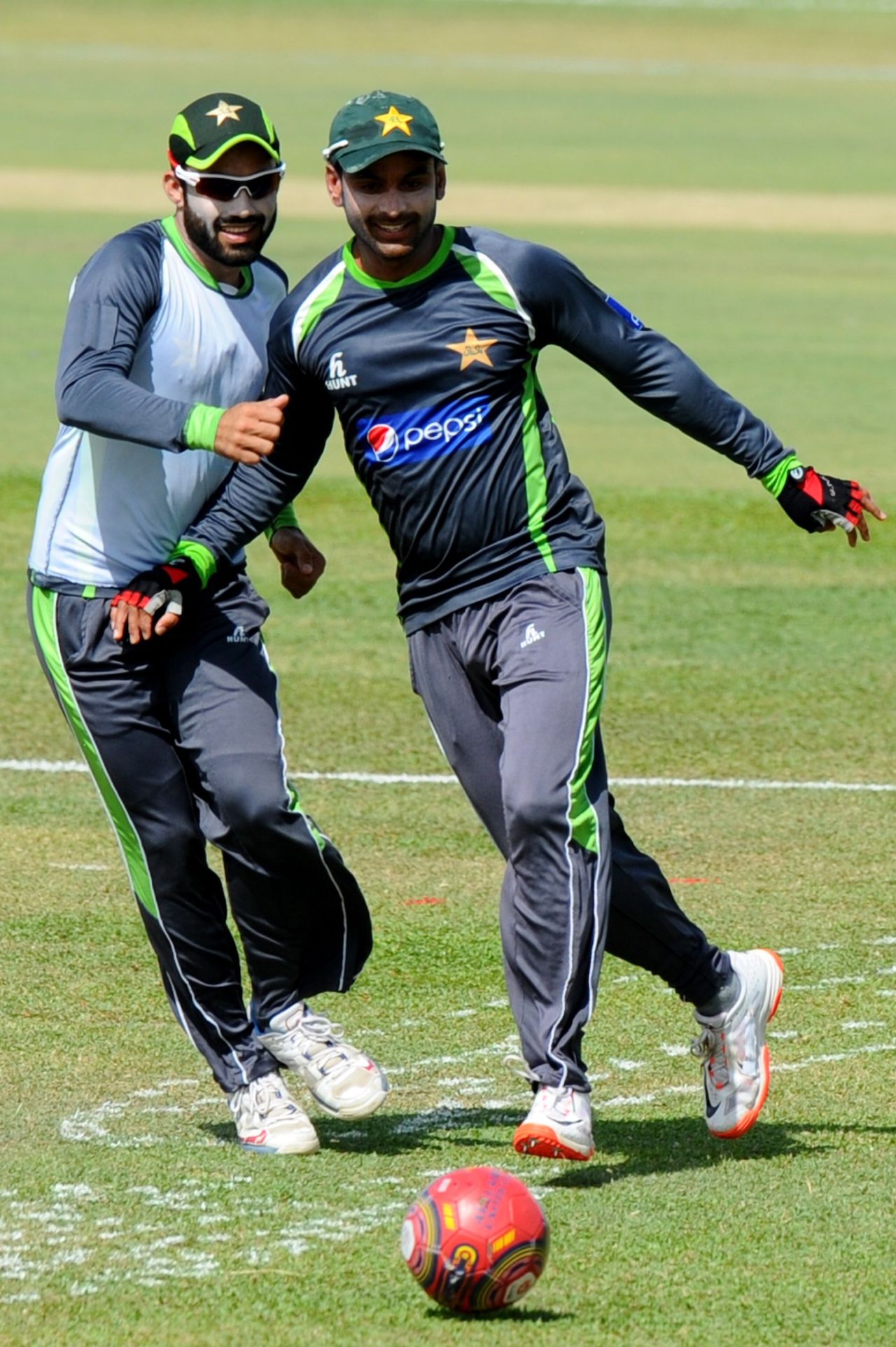 Mohammad Rizwan (left) and Mohammad Hafeez play football during a training session the day before the first ODI againstSri Lanka, Dambulla, July 10, 2015