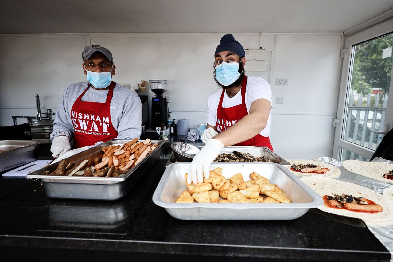Surrey's Amar Virdi (right) making food with chef Jav Sahota to be distributed to homeless and those in need at the NishkamSWAT kitchen in Southall, London, May 13, 2020