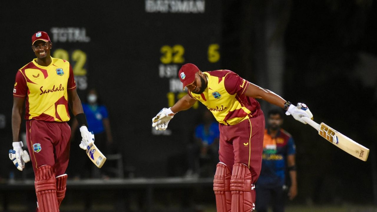 Kieron Pollard soaks in the applause after hitting six sixes in an over as Jason Holder looks on, West Indies vs Sri Lanka, 1st T20I, Coolidge, March 3, 2021