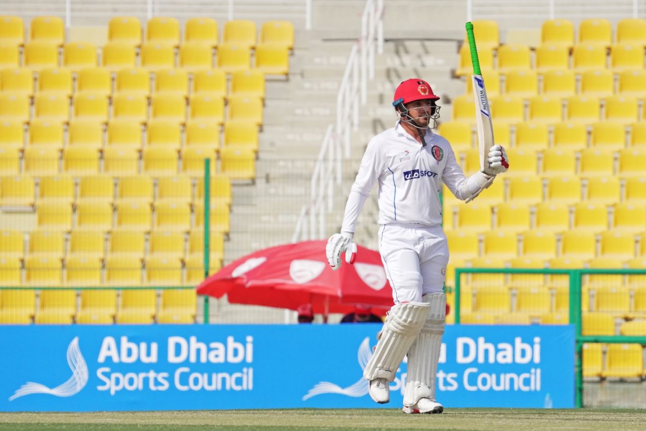 Nasir Jamal raises his bat on scoring a maiden Test half-century, Afghanistan v Zimbabwe, 2nd Test, 2nd day, Abu Dhabi, March 11, 2021