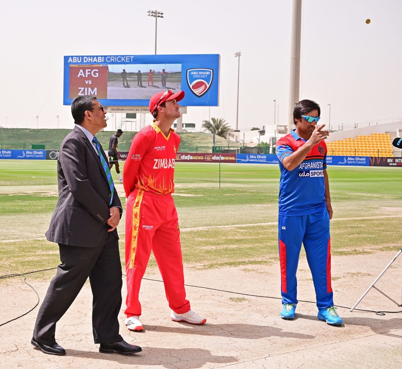 Asghar Afghan flips the coin, Afghanistan vs Zimbabwe, 1st T20I, Abu Dhabi, March 17, 2021