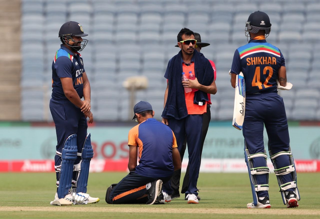Rohit Sharma is attended to by the physio after he hurt his arm, India vs England, 1st ODI, Pune, March 23, 2021