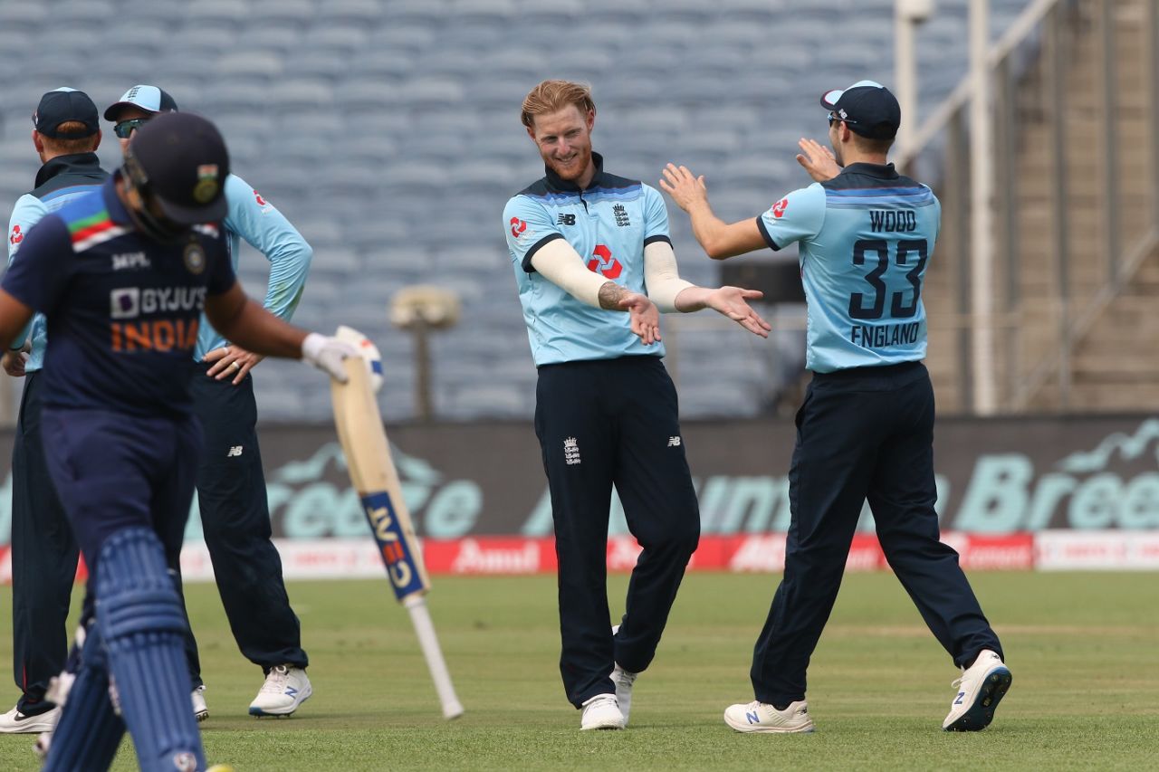 Ben Stokes and Mark Wood celebrate as Rohit Sharma walks back, India vs England, 1st ODI, Pune, March 23, 2021