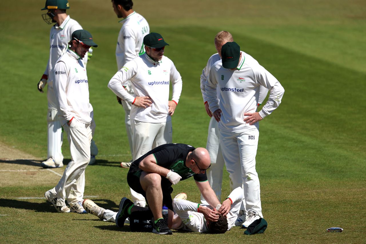 Colin Ackermann of Leicestershire is given treatment by Head of Sports Science and Medicine Will Garvey after being struck by a ball, LV= Insurance County Championship, day 2, Leicestershire vs Somerset, Grace Road, April 23, 2021