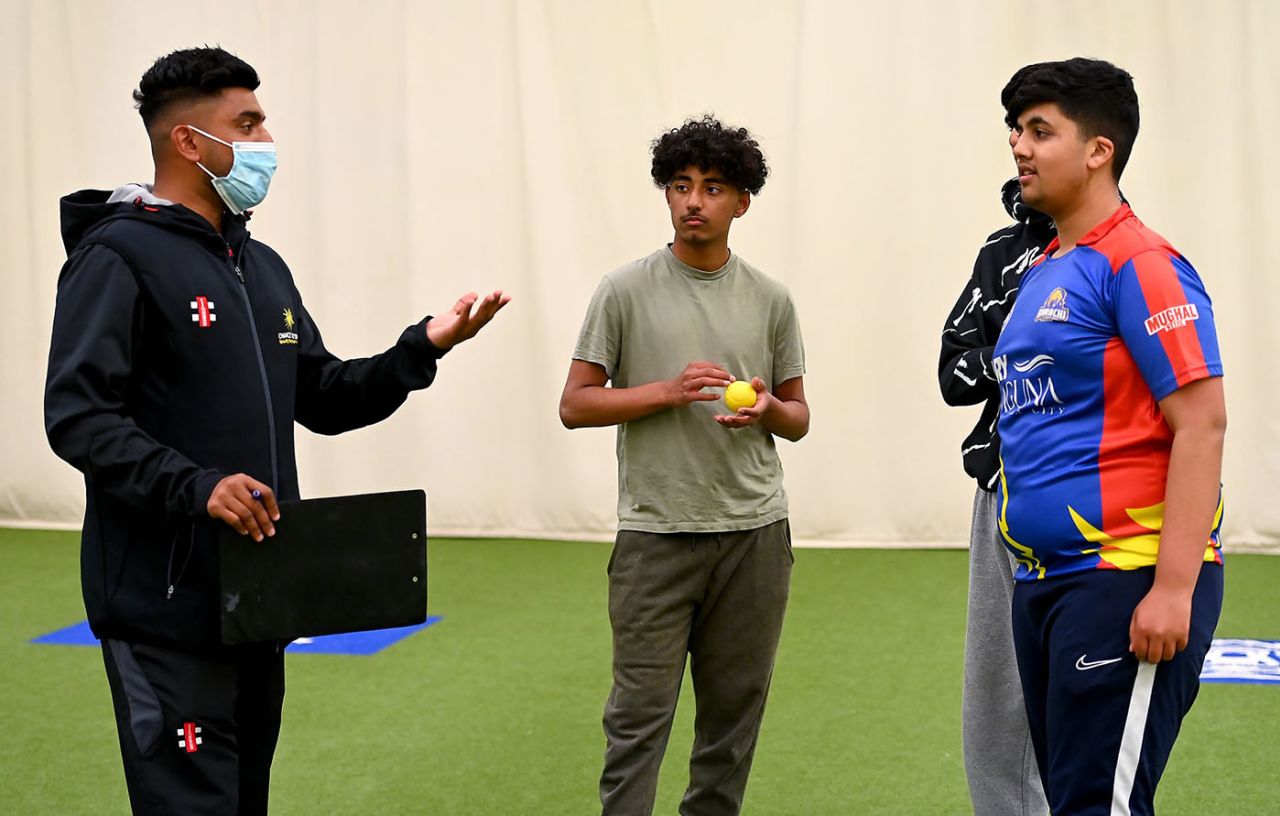 Shozair Ali (left) offers advice to kids demonstrating more connection to sides in Pakistan than Warwickshire, 28 April 2021