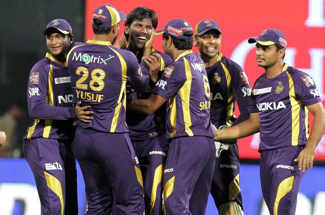 The Kolkata Knight Riders players celebrate a wicket, Bengaluru, April 10, 2012