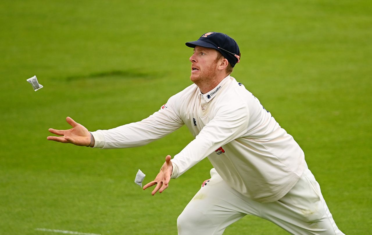 Simon Harmer juggles his hand-warmers in the slip cordon, Essex vs Warwickshire, LV= Insurance Championship, Chelmsford, 1st day, May 20, 2021