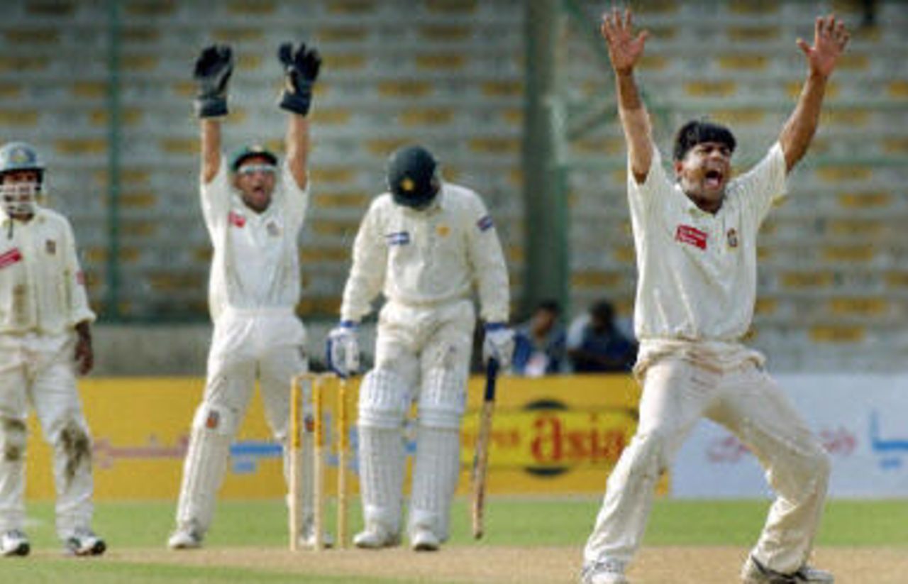 Bangladesh spinner Mohammad Rafique (R) with an appeal against Rashid Latif (C), with his teammates Habibul Bashar (L) and wicketkeeper Khaled Mashud (2nd-L)nst during the second day of the first Test, Bangladesh and Pakistan, 21 August 2003.