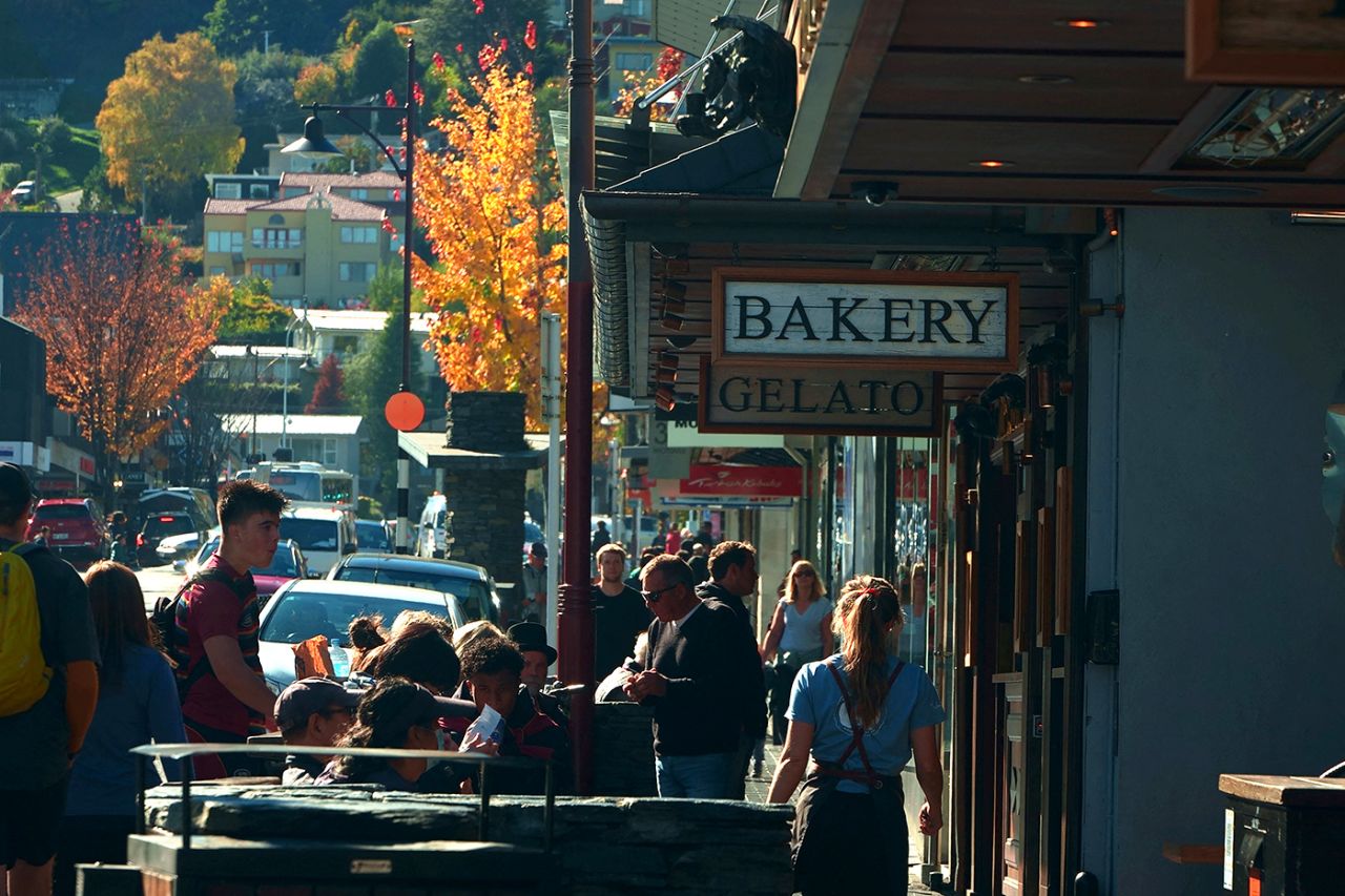 Tourists mill about in Queenstown, April 21, 2021