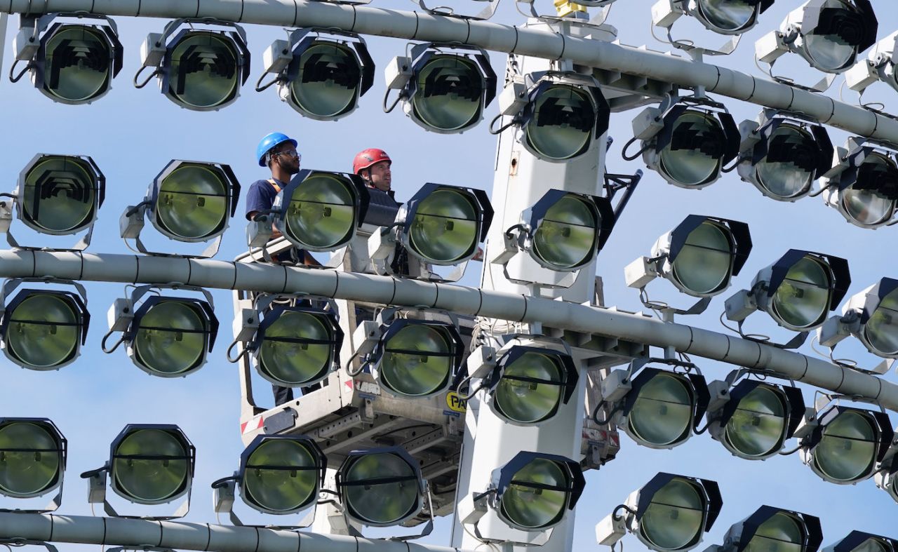 Two engineers work on the Lord's flood lights, Lord's, August  10, 2021