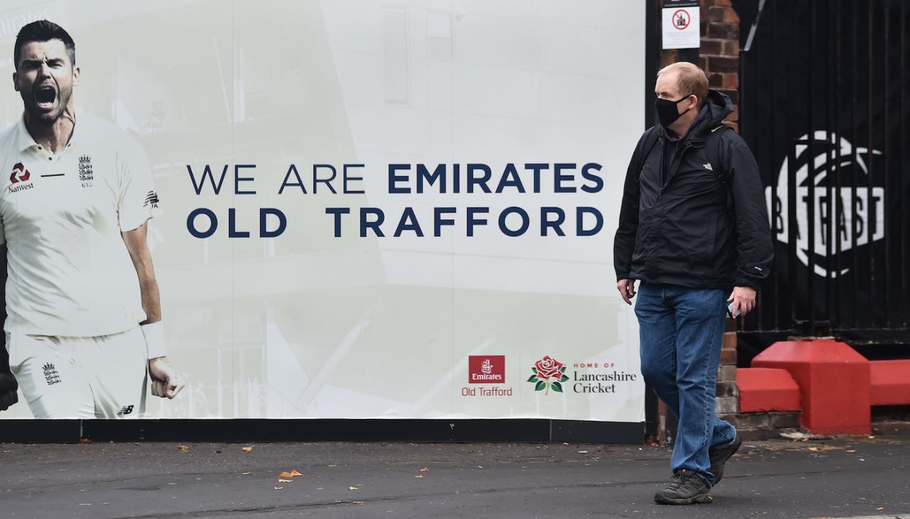 A wasted day - a spectator walks past a James Anderson hoarding at the entrance to Old Trafford, England vs India, 5th Test, Manchester, 1st day, September 10, 2021