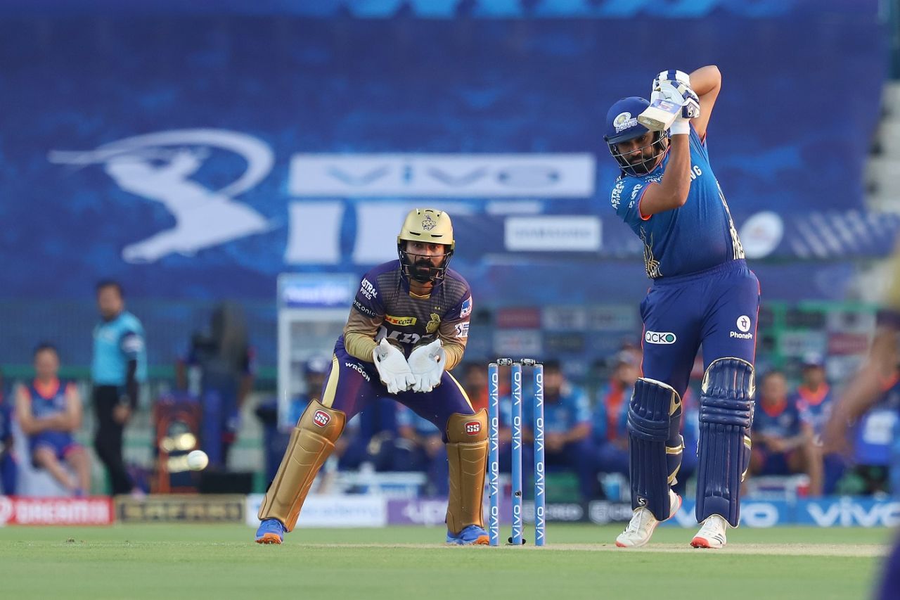 Rohit Sharma punches through the off side as Dinesh Karthik looks on, Mumbai Indians vs Kolkata Knight Riders, Abu Dhabi, IPL 2021, September 23, 2021