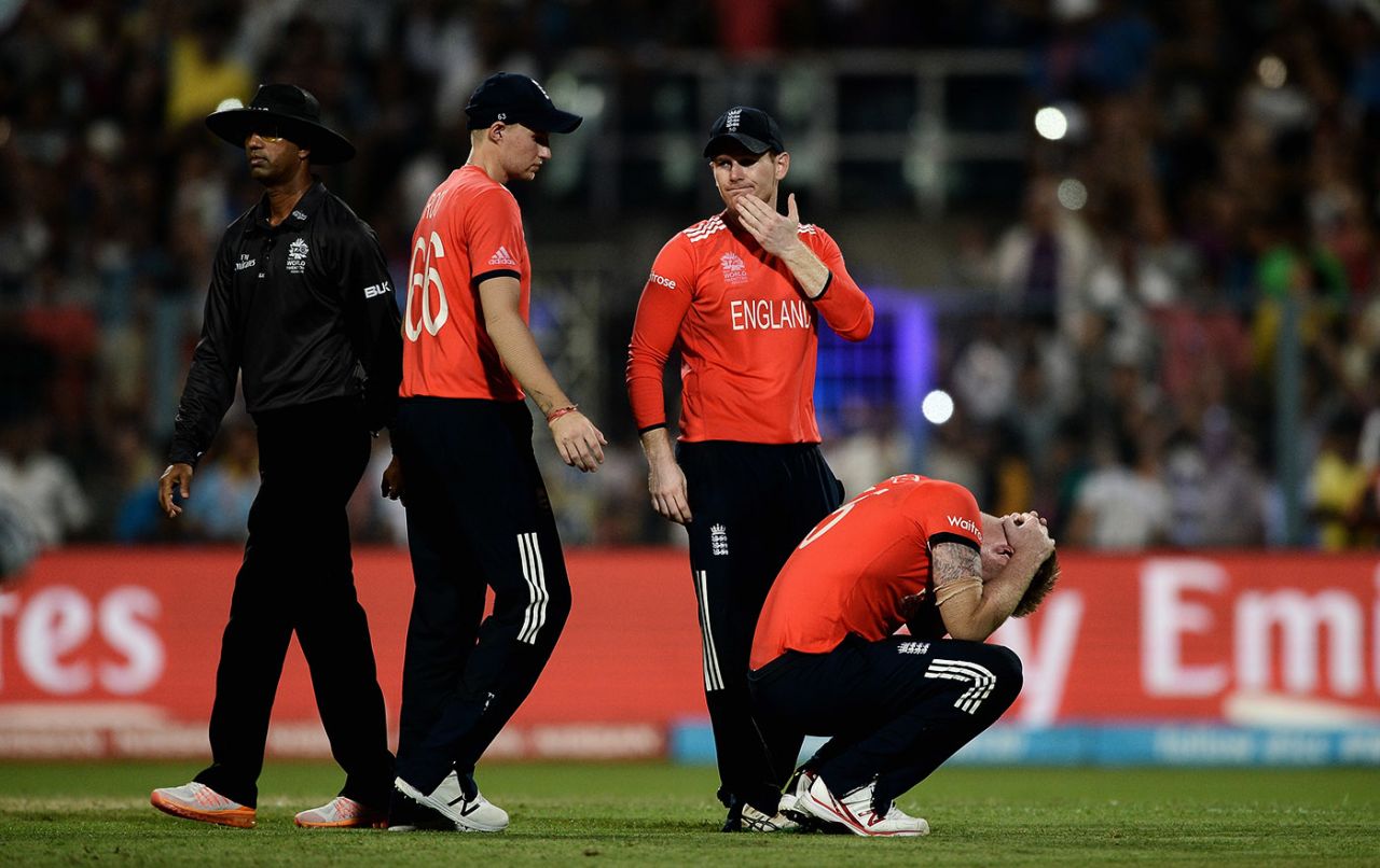 Joe Root and Eoin Morgan stand beside an upset Ben Stokes hunched on the ground, England v West Indies, World T20 2016, final, Kolkata, April 3, 2016