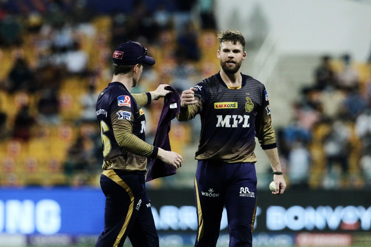 Eoin Morgan hands Lockie Ferguson a towel, Mumbai Indians vs Kolkata Knight Riders, Abu Dhabi, IPL 2021, September 23, 2021