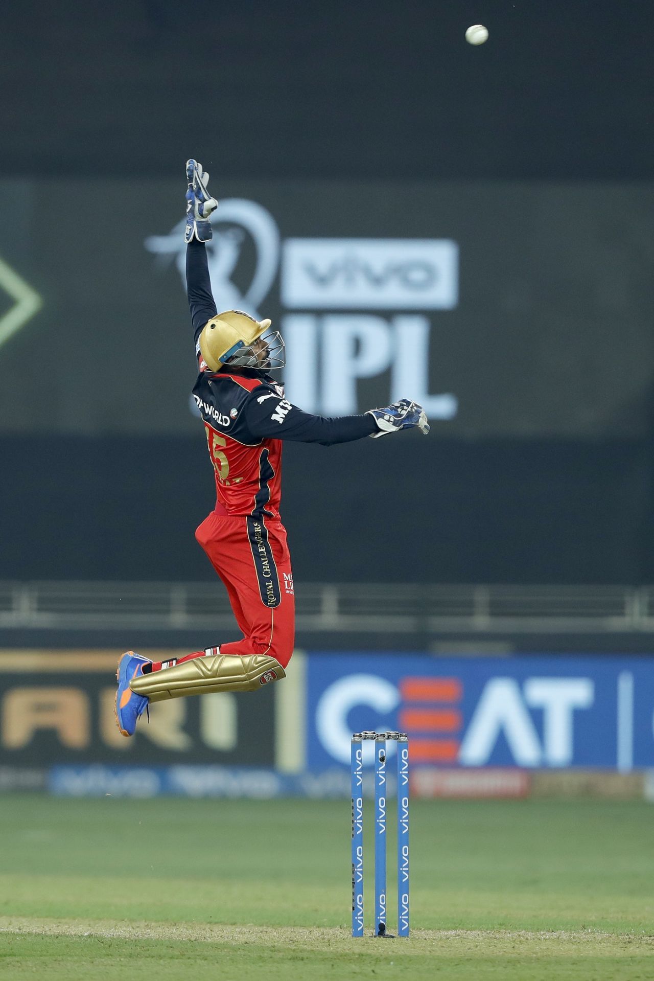 KS Bharat jumps in an attempt to collect a throw, Rajasthan Royals vs Royal Challengers Bangalore, Dubai, IPL 2021, September 29, 2021