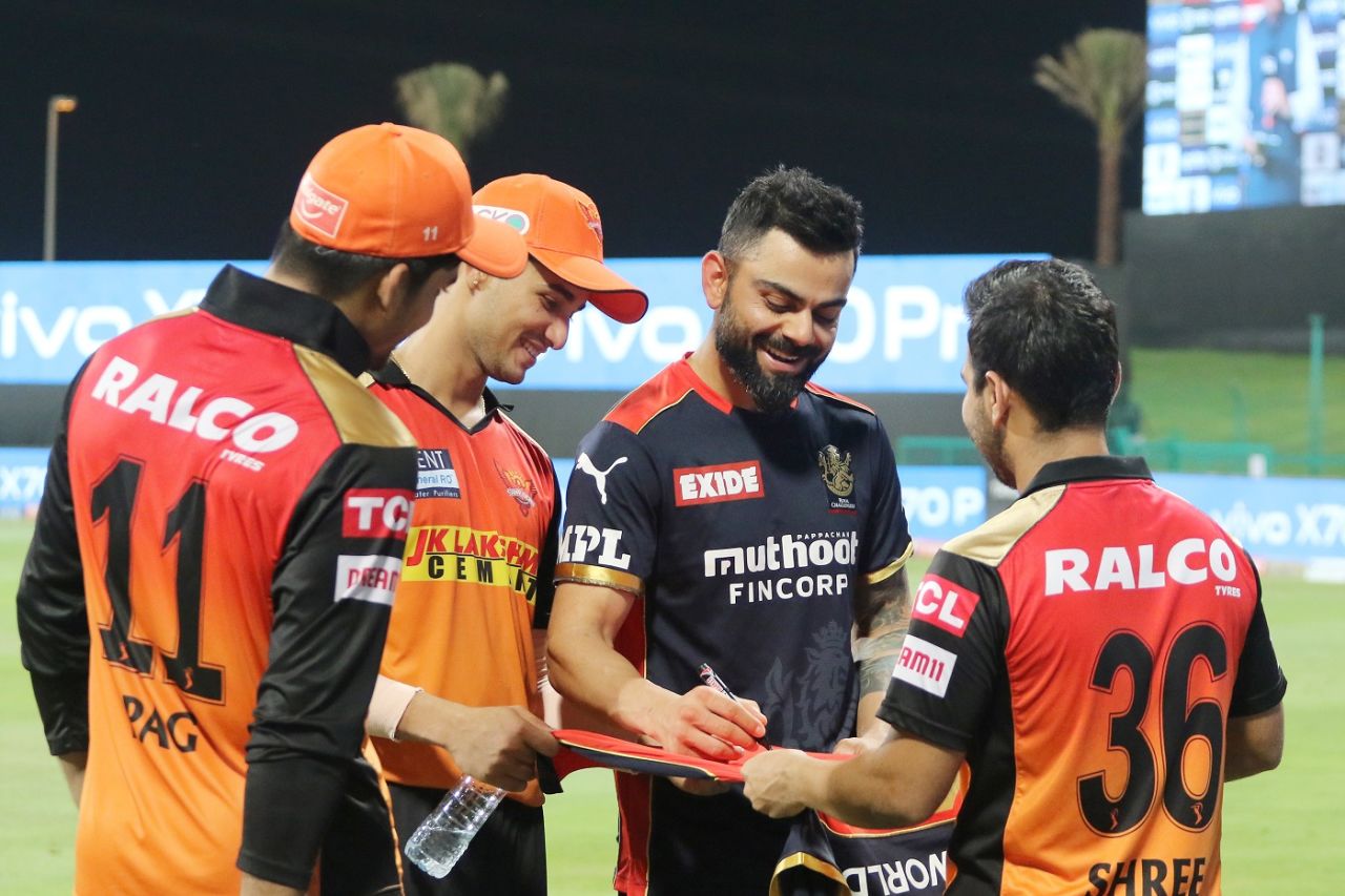 Virat Kohli shares a light moment with players from the opposition team, Royal Challengers Bangalore vs Sunrisers Hyderabad, IPL 2021, Abu Dhabi, October 6, 2021