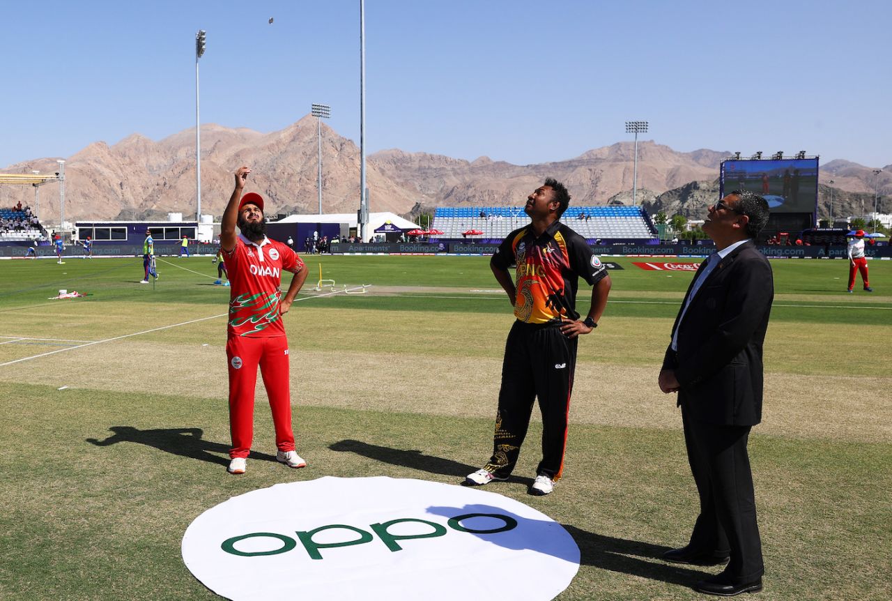 Zeeshan Maqsood flips the coin as Assad Vala looks on, Oman vs Papua New Guinea, T20 World Cup, Muscat, October 17, 2021