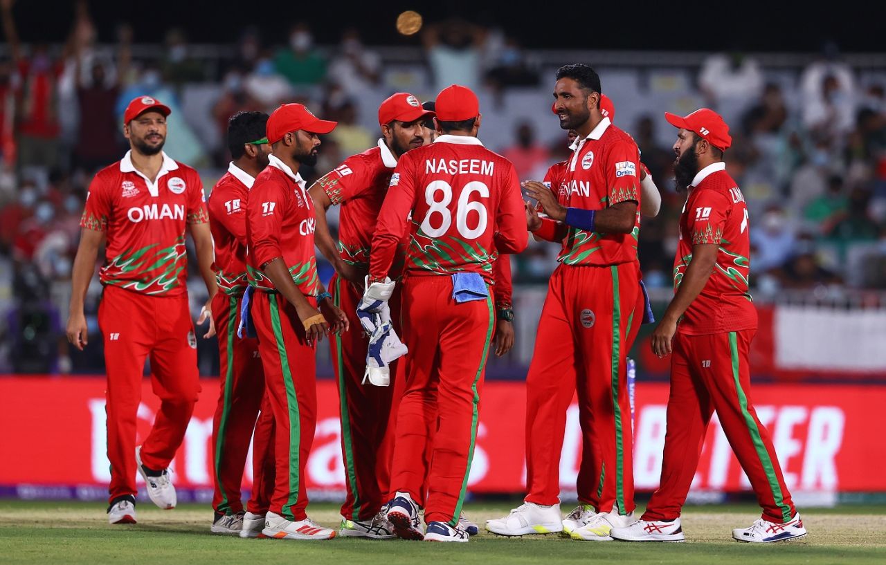 Oman's players gather in the middle after a successful moment in the field, Oman vs Bangladesh, T20 World Cup, Al Amerat, October 19, 2021