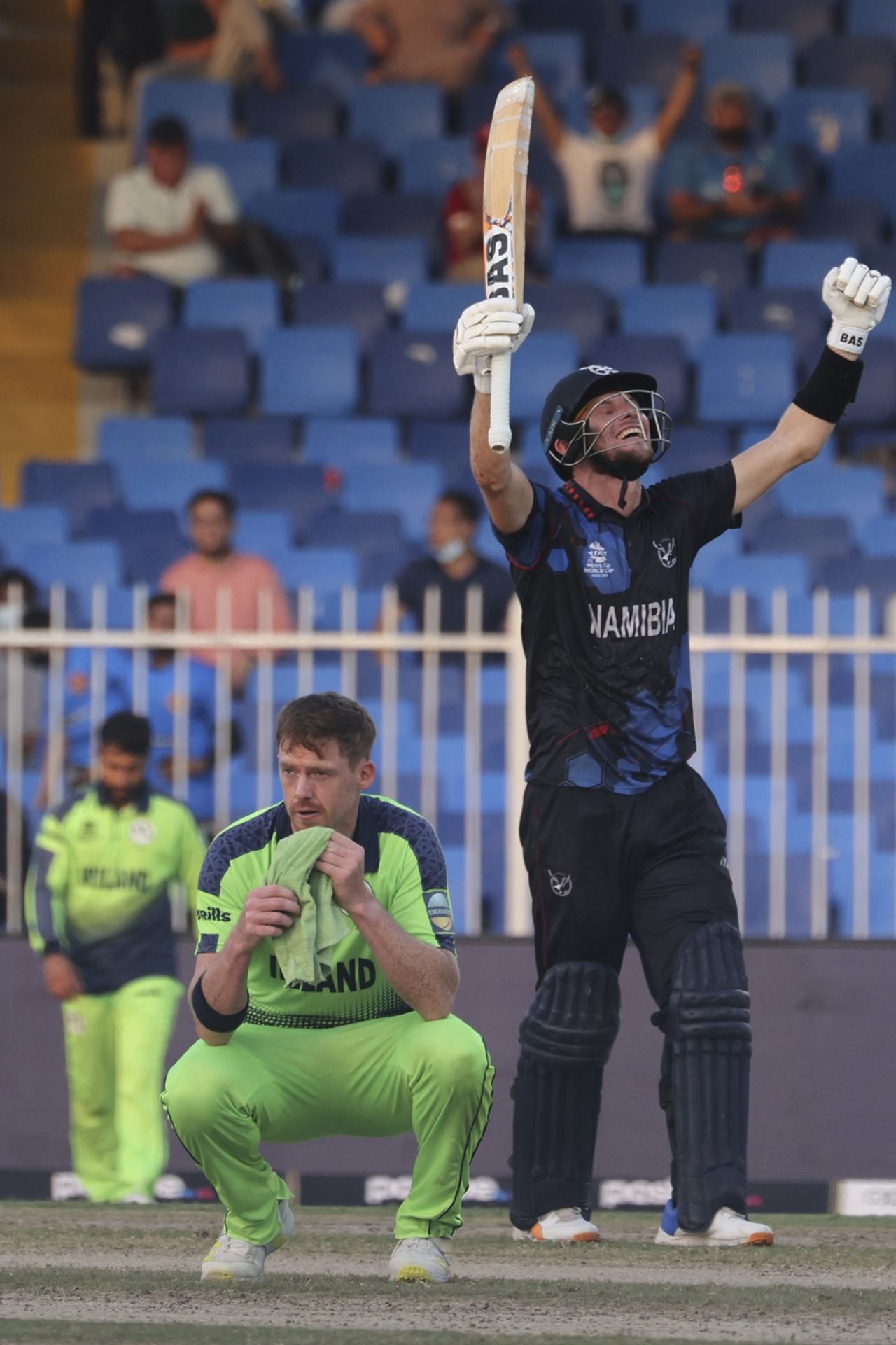 Gerhard Erasmus is elated after Namibia's win while a disappointed Craig Young looks on, Ireland vs Namibia, T20 World Cup, Sharjah, October 22, 2021