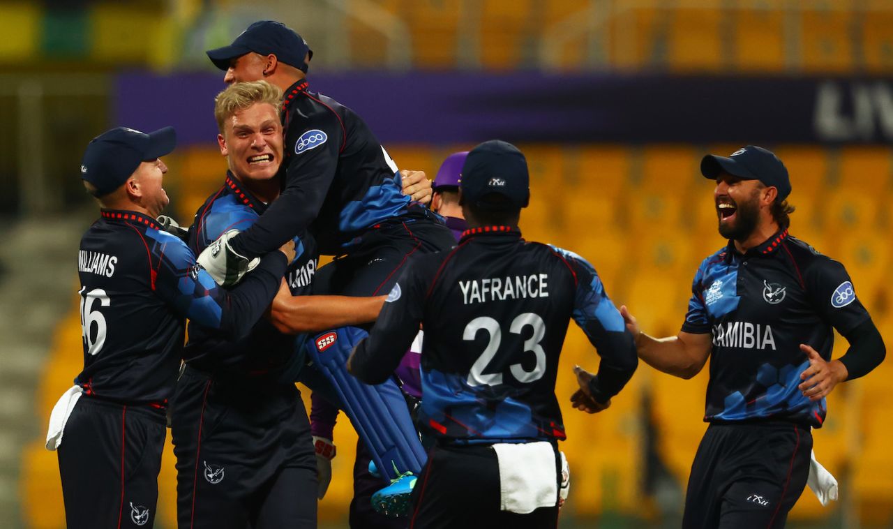 Ruben Trumpelmann is mobbed by his team-mates in the first over, Scotland vs Namibia, T20 World Cup 2021, Group 2, Abu Dhabi, October 27, 2021