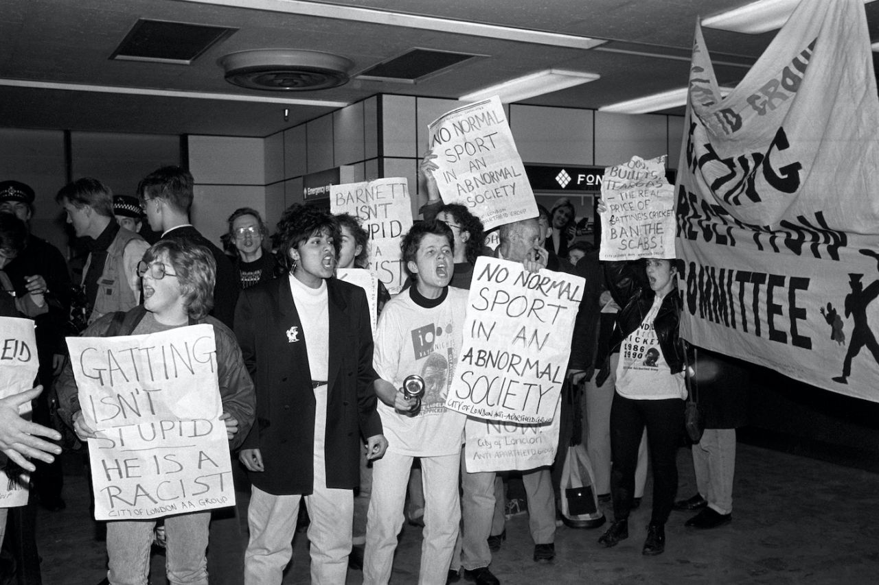 Banner waving protesters at Heathrow Airport where four members of the rebel cricket team returned home from South Africa, Feb 24, 1990
